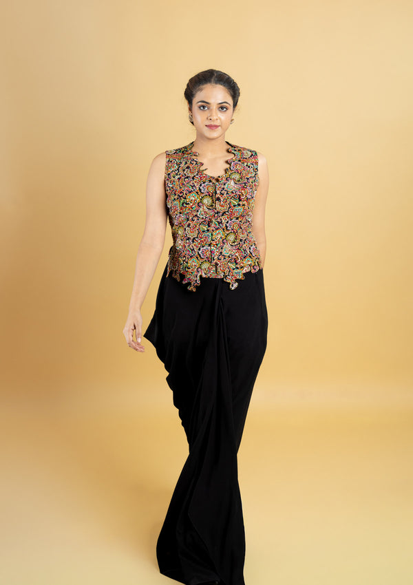 Designer indo western attire, cowl skirt with a corset top, top highlighted with hand embroidery